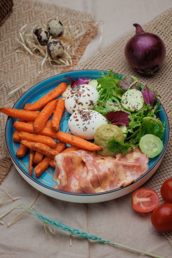 Sweet potato fries with mortadella, soft egg, guacamole and cheese sauce